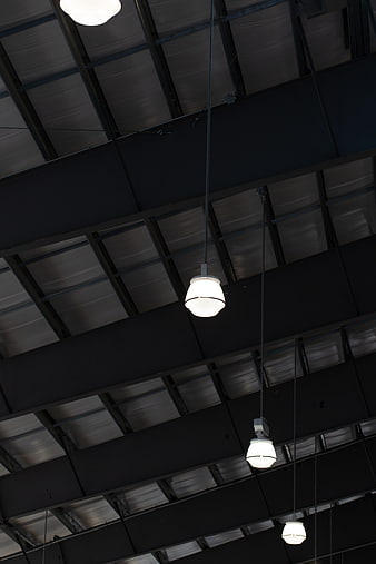 Industrial ceiling with hanging pendant lights and metal beams