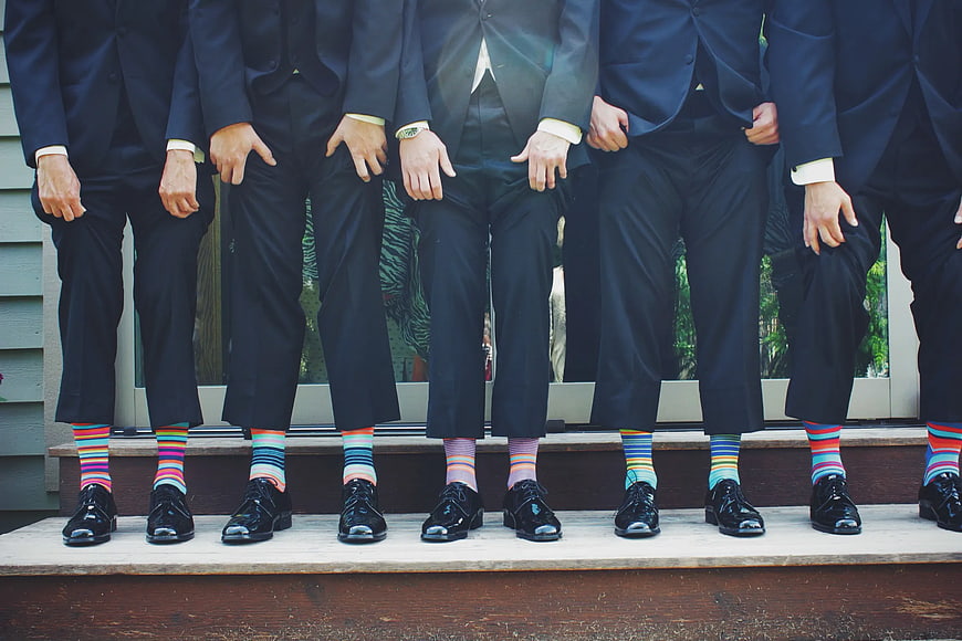 Groomsmen Wearing Colorful Striped Socks in Suits