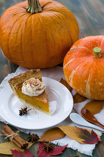 Slice of Pumpkin Pie with Whipped Cream and Autumn Decor