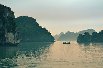 Lone Fishing Boat in Ha Long Bay at Dusk