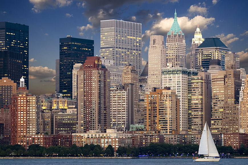New York City Skyline at Dusk with Sailboat on Water