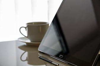 Tablet with Stylus and Coffee Cup on Desk