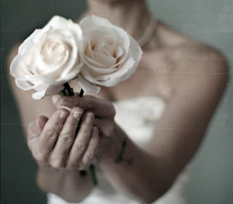 Bride holding white roses with vintage film grain texture