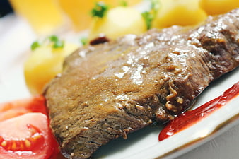 Close-up of Roast Beef with Potatoes and Tomatoes