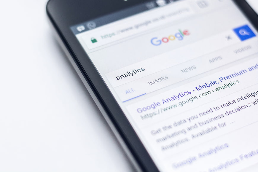 Smartphone displaying Google Analytics search results on mobile browser