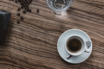 Top View of Espresso Cup on Wooden Table with Coffee Beans
