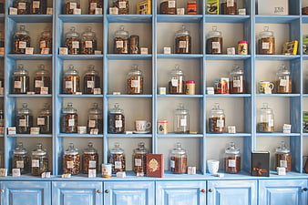 Blue Shelves Filled with Glass Tea Jars and Loose Leaf Tea