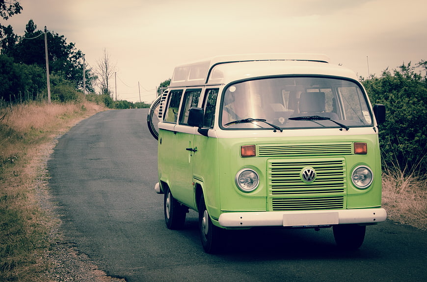 Vintage Green Volkswagen Camper Van on Country Road