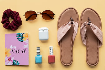 Summer vacation essentials flat lay with sandals and sunglasses