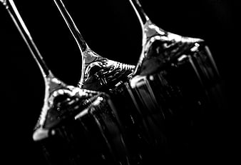 Black and white macro of wine glasses with liquid