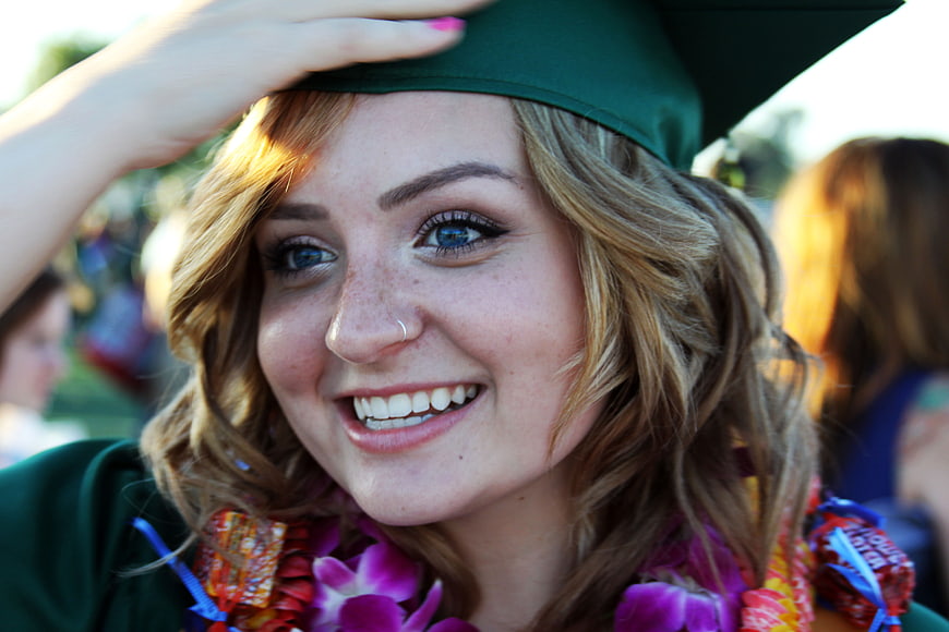 Happy Female Graduate Smiling in Cap and Gown