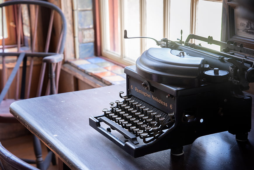 Vintage Remington Typewriter on Wooden Desk by Window