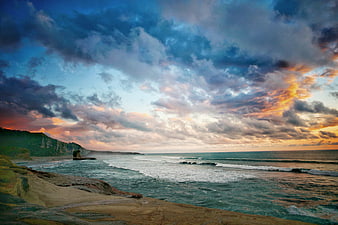 Dramatic Coastal Sunset with Rocky Cliffs and Ocean Waves