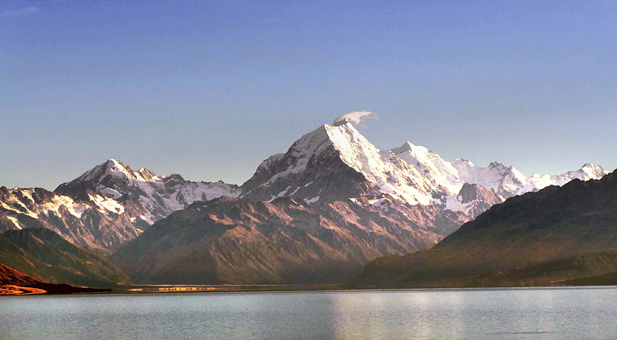 Majestic Snow-Capped Mountain Peak Reflected in Calm Lake