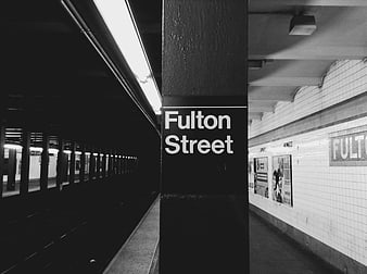 Fulton Street subway station sign in black and white