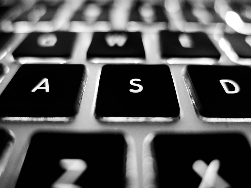 Close-up of black laptop keyboard keys in black and white