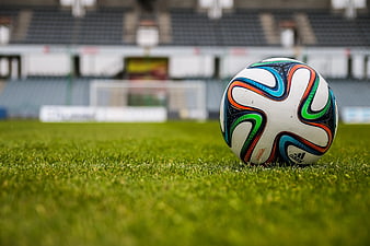 Adidas Soccer Ball on Green Grass Field in Stadium