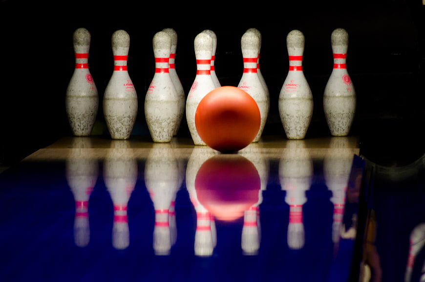 Orange Bowling Ball and Pins on Lane with Reflection