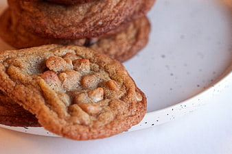 Close-up of fresh peanut butter cookies on a speckled plate