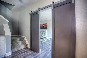 Modern Interior with Gray Barn Doors and Staircase