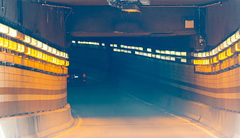 Motion Blur Car Driving Through Illuminated Tunnel at Night