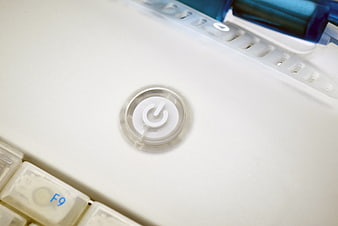Close-up of white laptop power button with keyboard keys