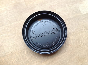 Black Coffee Cup Lid on Wooden Surface