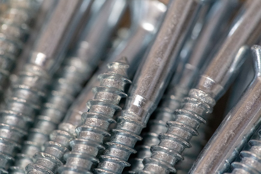 Close-up of silver metal screws with sharp threads