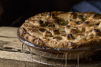 Rustic homemade apple pie with lattice crust on wooden table