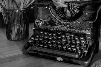 Vintage black and white typewriter on wooden desk