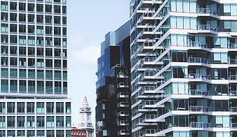 Modern Glass Skyscrapers and Historic Clock Tower in Urban Cityscape