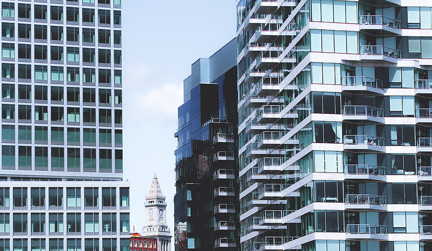 Modern Glass Skyscrapers and Historic Clock Tower in Urban Cityscape