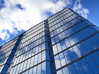 Modern Glass Skyscraper Architecture with Blue Sky Reflection