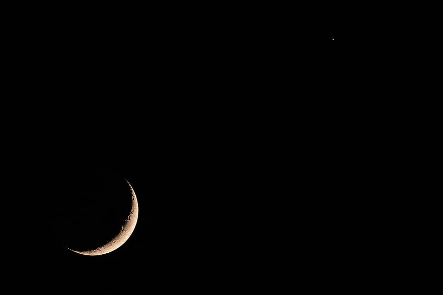 Crescent Moon and Star in Dark Night Sky