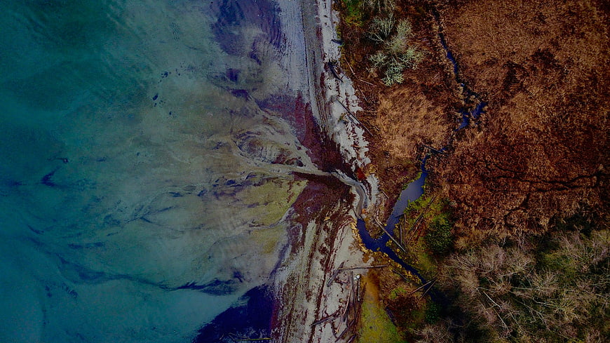 Aerial View of River Mouth Meeting Turquoise Ocean Waters