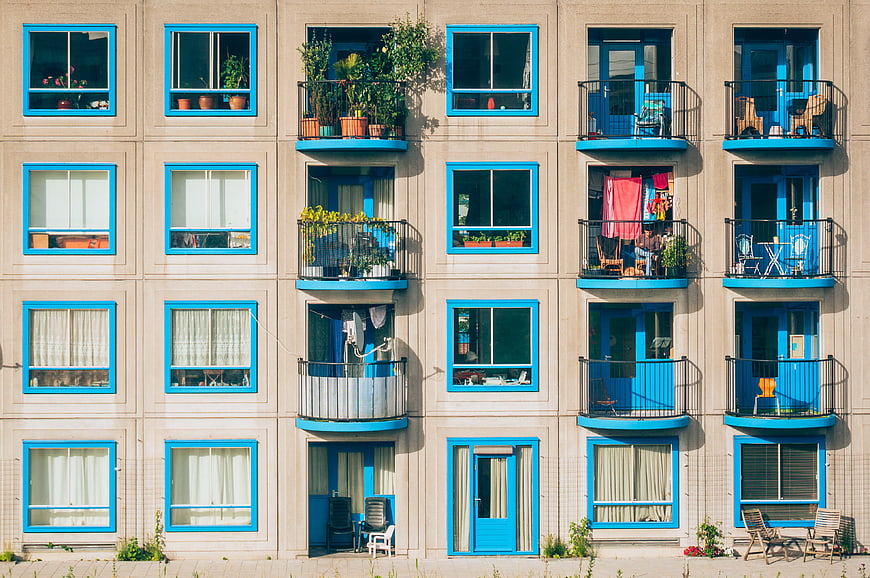 Colorful apartment building facade with blue windows and balconies
