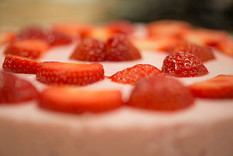 Close-up of fresh strawberry slices on creamy cake