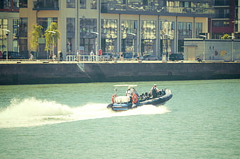 Rigid Inflatable Boat Speeding on Urban River