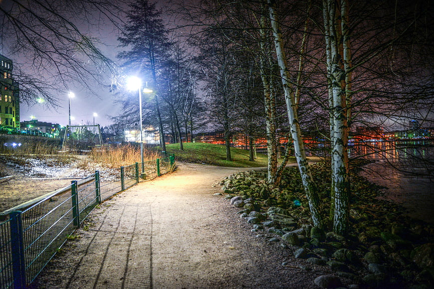 Illuminated Winter Path in Helsinki Park at Night