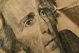 Close-up of Benjamin Franklin on a worn US dollar bill
