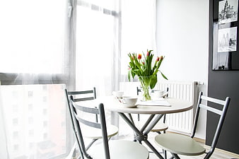 Bright Dining Table with Tulips and White Chairs