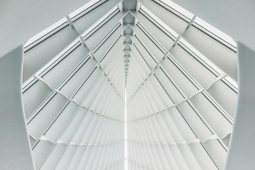 Symmetrical white architectural ceiling with geometric lines