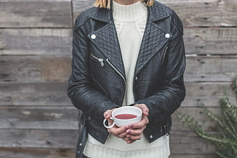 Woman in Leather Jacket Holding Warm Drink