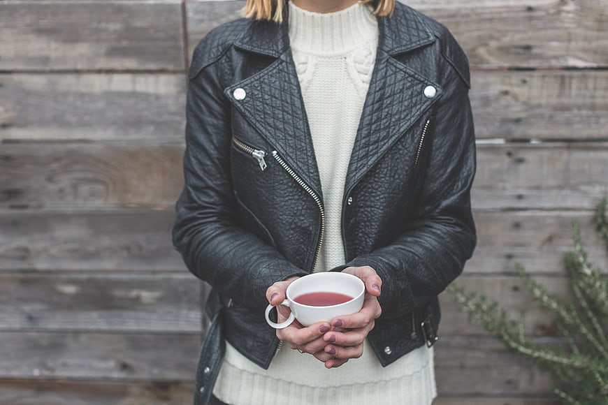 Woman in Leather Jacket Holding Warm Drink