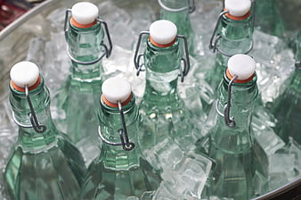 Green glass swing-top bottles chilling in ice bucket