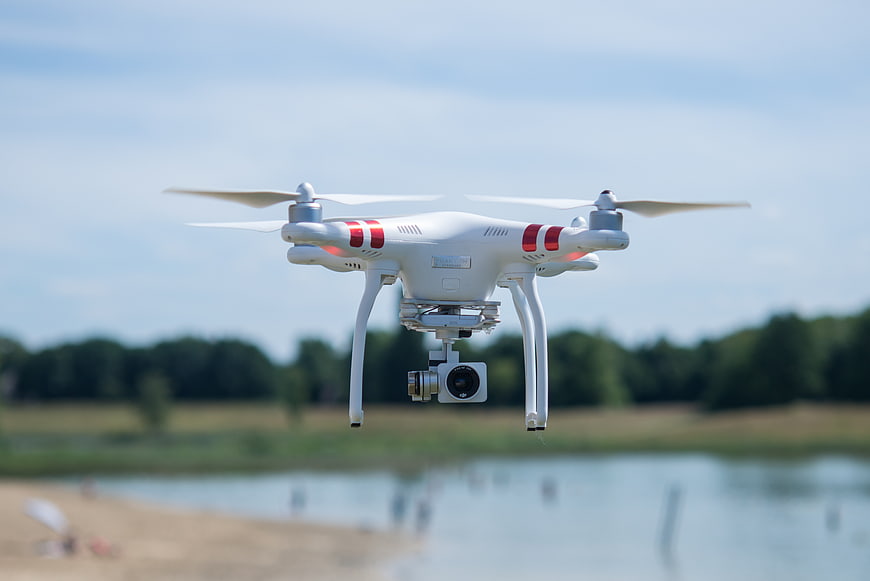 White Drone Flying Over Lake