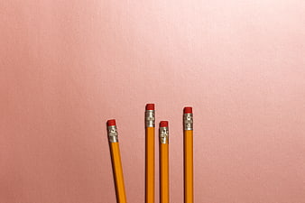 Yellow pencils on pink background with copyspace