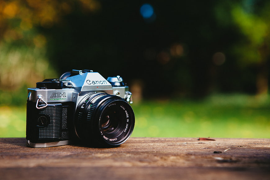 Vintage Canon AE-1 Film Camera on Wooden Surface