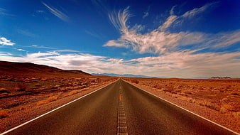 Endless Desert Highway Under Dramatic Blue Sky