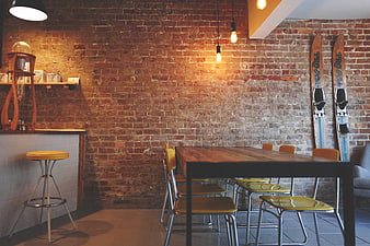Modern Loft Interior with Exposed Brick Wall and Wooden Table